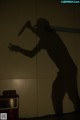 A silhouette of a man holding a knife in his hand.