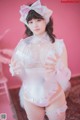 A woman in a white lingerie holding a large bubble.