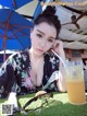 A woman sitting at a table with a glass of orange juice.